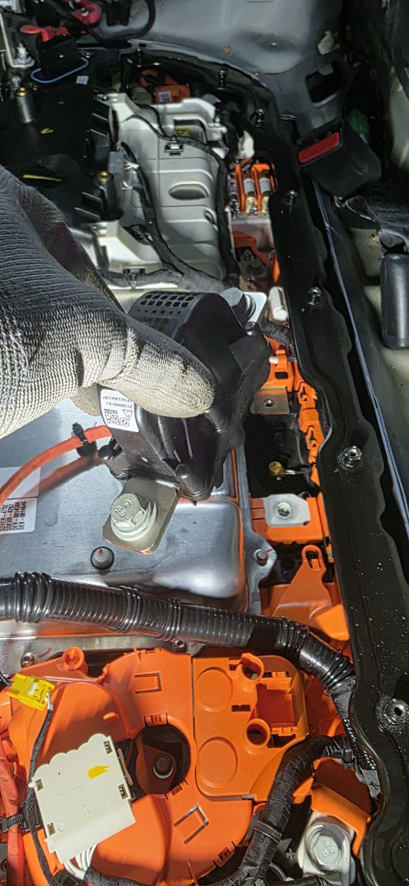 Tesla Model 3 pyrofuse area with HV-rated gloves — mandatory PPE
