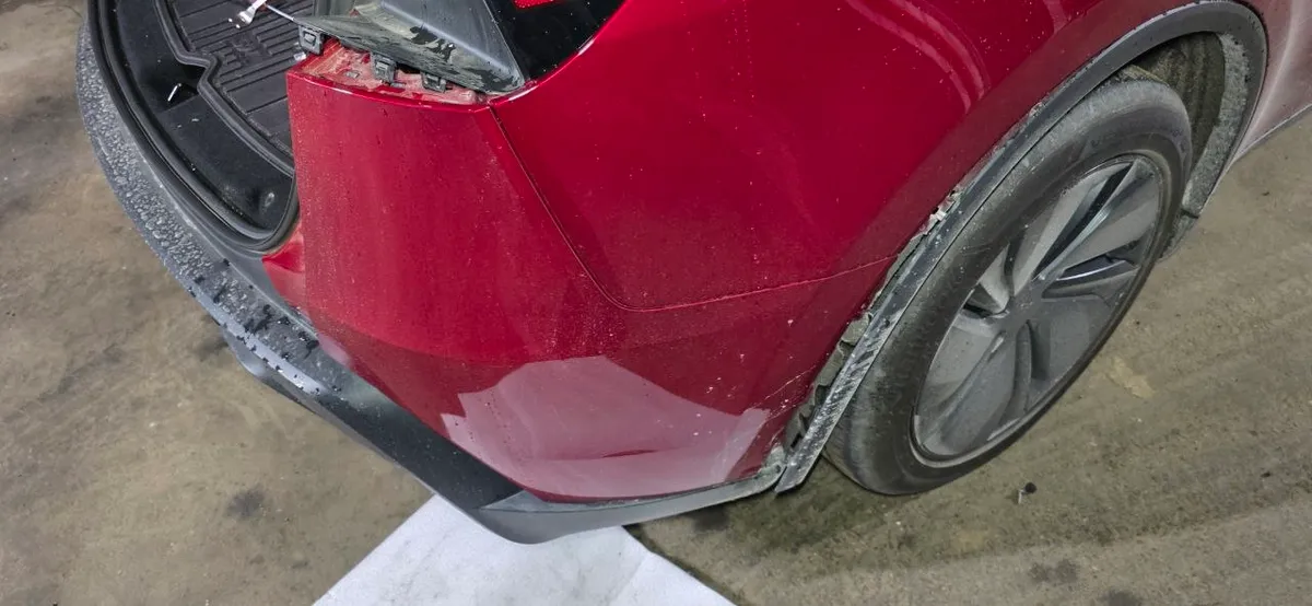 Rear corner of the Model Y Juniper with the bumper corner partially released