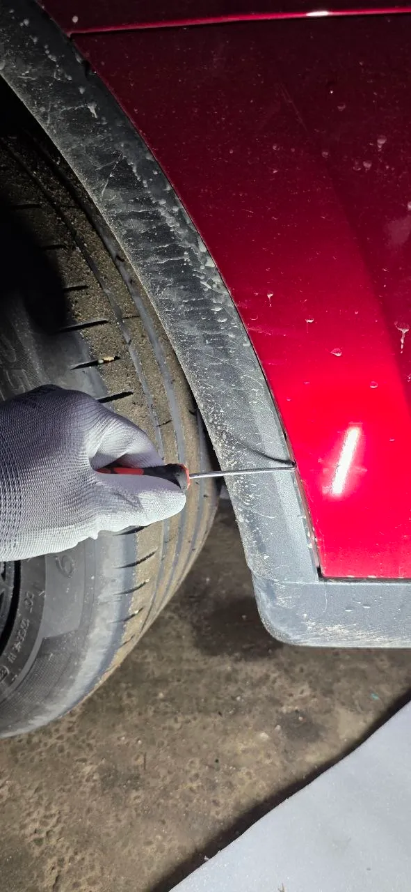 Releasing the wheel arch liner fasteners along the bumper edge