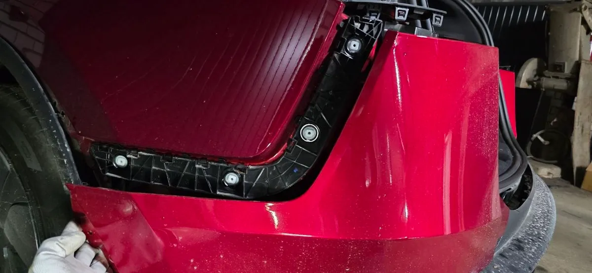 Bumper corner pulled free showing the side mounting bracket