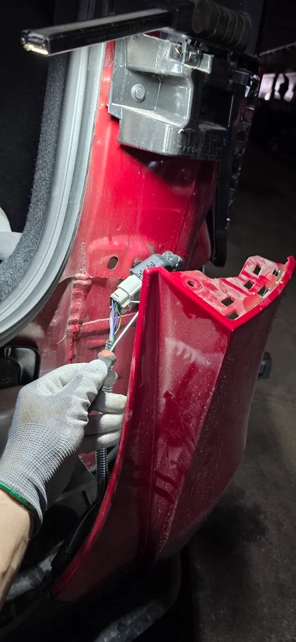 Disconnecting the bumper wiring harness connector while supporting the panel