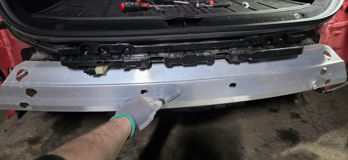 Aluminum impact bar exposed on the car after bumper removal