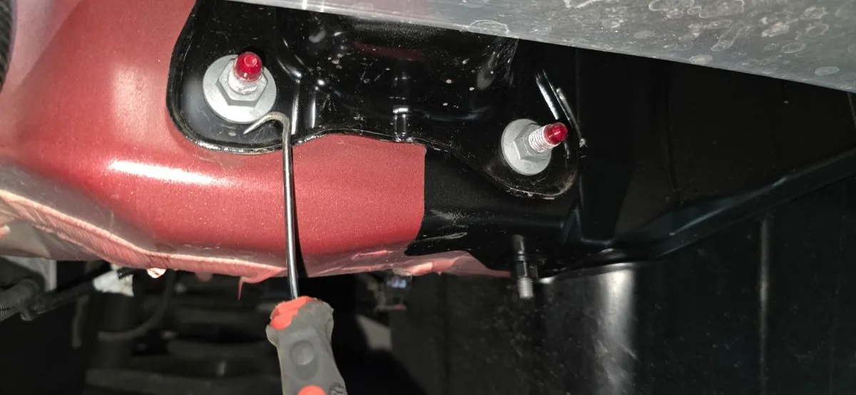 Impact bar mounting studs with red factory paint marks