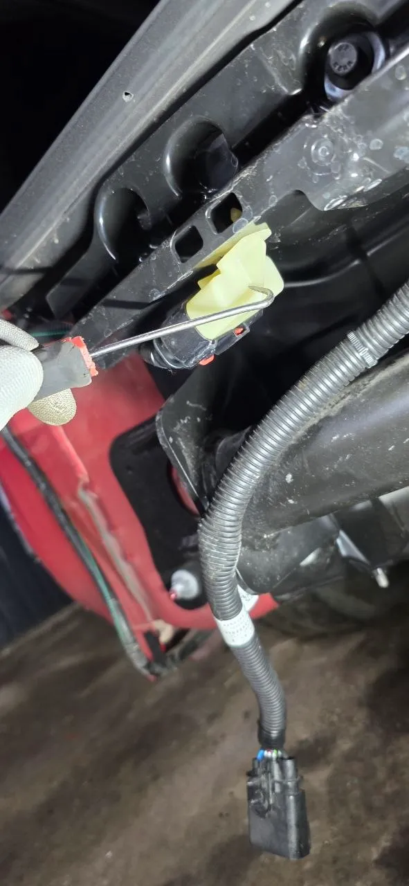 Routing the tow hitch wiring up through the body opening with a hook tool