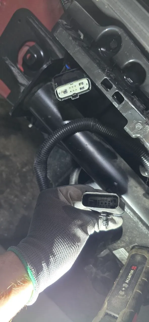 Plugging the tow hitch harness into the car's factory connector