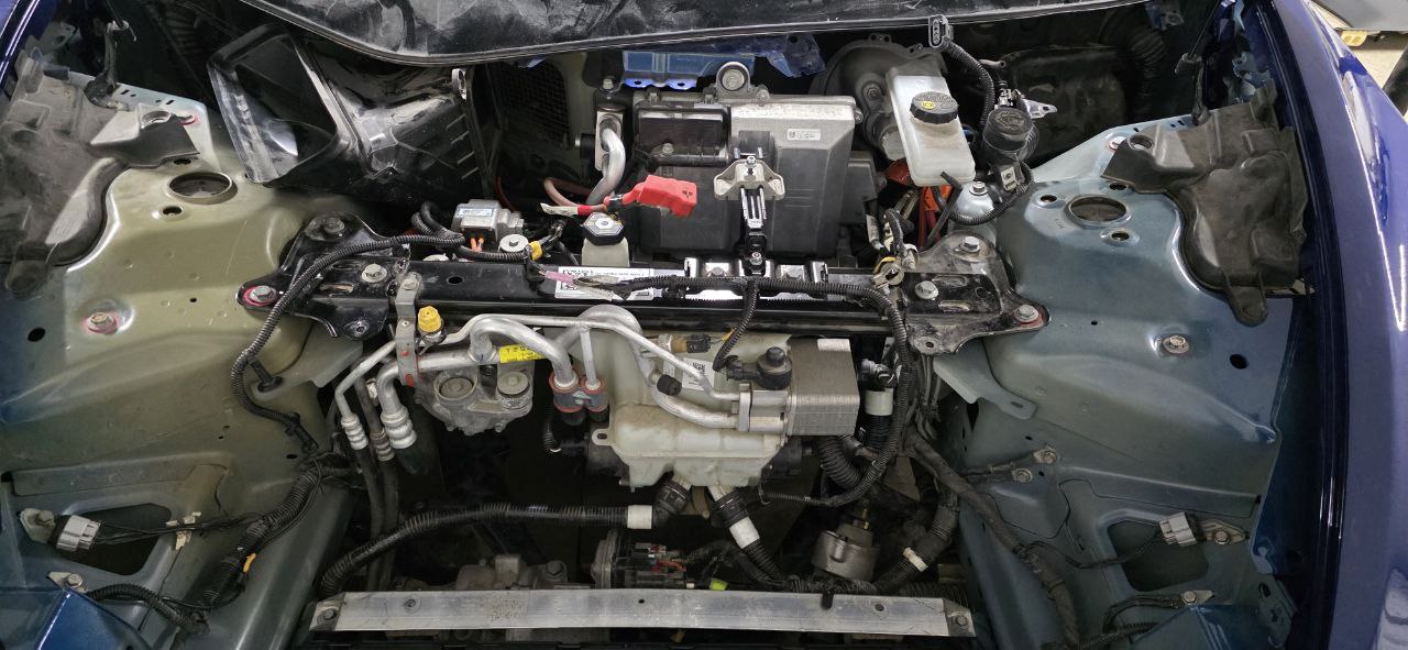 Tesla Model 3 frunk fully opened showing thermal management system and battery area