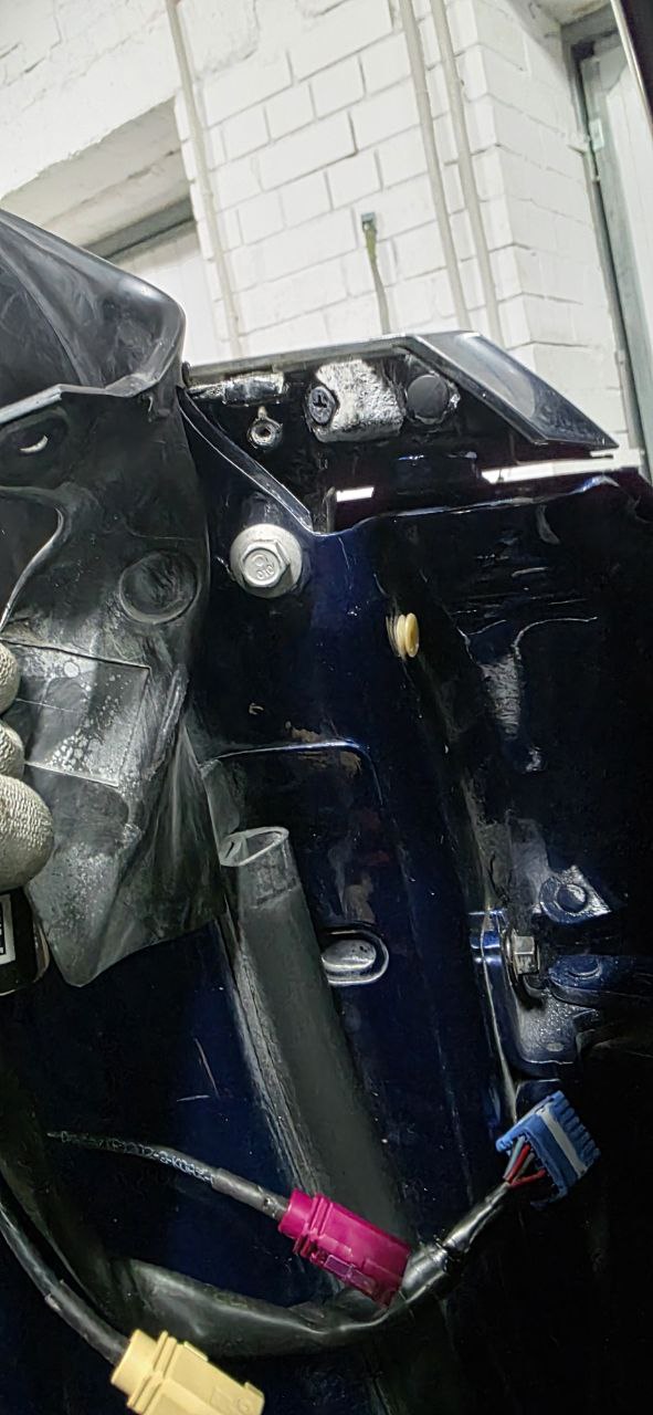 Mirror in position showing bolts and harness routing